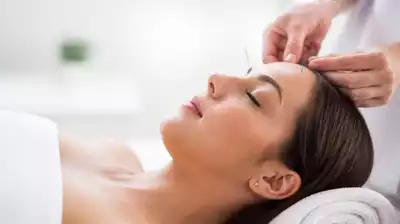 User receiving acupuncture treatment